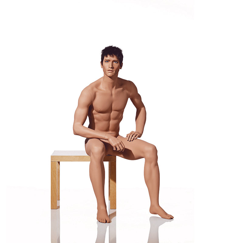 Realistic male mannequin from Hindsgaul® in a sitting pose.