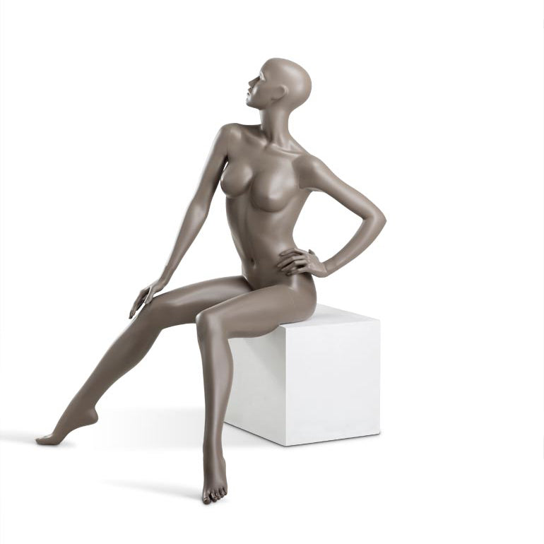 Female mannequin from Hindsgaul® sitting. COY is a semi-faceless, female mannequin series with 9 poses reflecting a confident and feminine attitude.